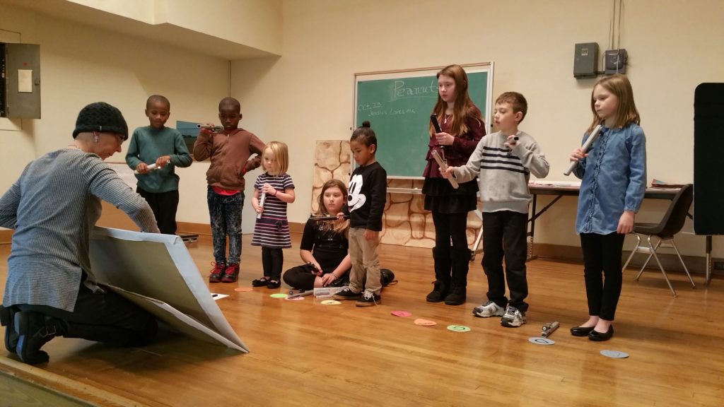 Peanut Ringers Director Sarah Hallberg teaches the kids a new song during rehearsal in Emerson Hall.
